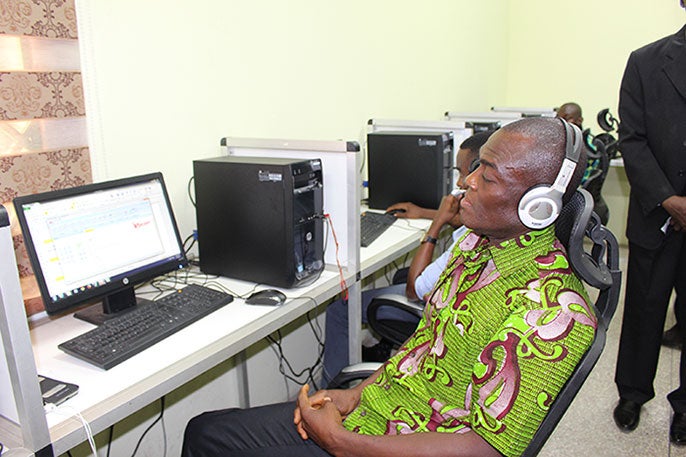 Copperfield Banini, Senior Scientist at Ghana?s Ministry of Agriculture takes a call at the e-Agriculture center.