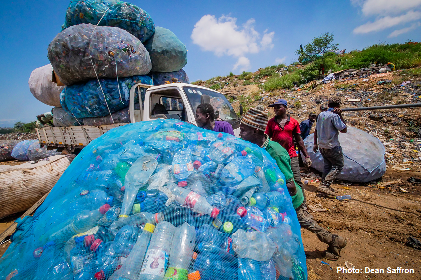 A group of informal workers collecting and transporting used plastic bottles on an open field. (Photo: Dean Saffron) A group of informal workers collecting and transporting used plastic bottles on an open field. (Photo: Dean Saffron)