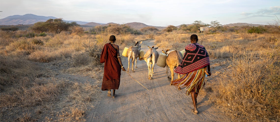 Women carrying water collected from the well Women carrying water collected from the well